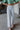 Frontal view of the Loretta Straight Leg Jeans that features a light wash denim, a swirl print design, two front pockets, a button and zipper closure, two back pockets, and a wide leg fit.
