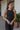 Frontal view of the Keep Cool Tank Top that features a black terry cloth material, a round neckline, a sleeveless design with thin straps, and a flowy fit.