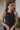 Frontal view of the Keep Cool Tank Top that features a black terry cloth material, a round neckline, a sleeveless design with thin straps, and a flowy fit.