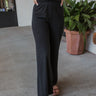 Frontal view of the Keep Cool Pants that features a black terry cloth material, a high-rise fit, a thick elastic band waist, and a wide leg fit.