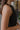 Side view of the Keep Cool Tank Top that features a black terry cloth material, a round neckline, a sleeveless design with thin straps, and a flowy fit.