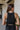 Back view of the Keep Cool Tank Top that features a black terry cloth material, a round neckline, a sleeveless design with thin straps, and a flowy fit.