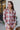 Frontal view of the Home Sweet Top that features a flannel material, a multi-colored plaid, a collar neckline, a button-up front, a front pocket, and a long cuffed sleeve.