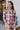 Frontal view of the Home Sweet Top that features a flannel material, a multi-colored plaid, a collar neckline, a button-up front, a front pocket, and a long cuffed sleeve.