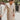 Frontal view of the Means Business Dress that features a cream colored chiffon material, a surplice lapel neckline, a long sleeve, a wrap front with a tie, and a mini length.