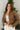 Front view of model wearing the Next Adventure Puffer Jacket in Brown that has a brown nylon material, a puffer design, a long sleeve, a zip-up front, and front pockets. 