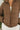 Close front view of model wearing the Next Adventure Puffer Jacket in Brown that has a brown nylon material, a puffer design, a long sleeve, a zip-up front, and front pockets. 