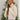 Frontal side view of model wearing the New Adventure Puffer Jacket in Cream that has a cream nylon material, a puffer design, a long sleeve, a zip-up front, and front pockets. 