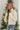 Frontal side view of model wearing the New Adventure Puffer Jacket in Cream that has a cream nylon material, a puffer design, a long sleeve, a zip-up front, and front pockets. 