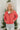 Front view of model wearing the Next  Adventure Puffer Jacket in Hibiscus that has a dark pink nylon material, a puffer design, a long sleeve, a zip-up front, and front pockets. 