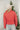 Back view of model wearing the Next Adventure Puffer Jacket in Hibiscus that has a dark pink nylon material, a puffer design, a long sleeve, a zip-up front, and front pockets. 