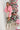 Full body front view of model wearing the All I Want Sweater, which features pink knit fabric with thick ribbed trim, a high round neck, and drop-shoulder long sleeves with folded cuffs