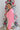 Side view of model wearing the All I Want Sweater, which features pink knit fabric with thick ribbed trim, a high round neck, and drop-shoulder long sleeves with folded cuffs