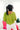 Back view of model wearing the Go Boldly Chenille Sweater in Green that has lime green chenille fabric, a v-neck and back, and long batwing sleeves