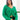 Front view of model wearing the Merry And Bright Sweater that has green knit fabric, a cropped waist, a ruched drawstring front, a v neckline, and long balloon sleeves.
