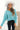 Front view of model wearing the Go Boldly Chenille Sweater in Blue that has blue chenille fabric, a cropped waist, a v-neckline, and long batwing sleeves