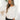 Front view of model wearing the Warm And Fuzzy Pullover in Ivory that has soft fleece fabric, long raglan sleeves, ribbed trim, and a round neckline