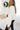 Side view of model wearing the Warm And Fuzzy Pullover in Ivory that has soft fleece fabric, long raglan sleeves, ribbed trim, and a round neckline