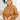 Front view of model wearing the No Plans Pullover in Brown that has light brown waffle-knit fabric, long batwing sleeves, a hood with an ivory drawstring, and a wide fit