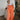 Full body front view of model wearing the Pop Of Color Pants that feature orange fabric, side pockets, a front zipper with a hook closure, and wide legs with pleated details.