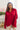 Front view of model wearing the Bristol Oversized Satin Top in Red that has red satin fabric, a button-up front with a collared neckline, one chest pocket, long sleeves with buttoned cuffs, and an oversized fit