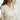 Front view of model wearing the Spot On Satin Top in Ivory that has ivory satin fabric with a monochromatic spot print, a button-up front with a collar and lapels, and long sleeves with buttoned cuffs. Shown tucked in