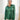 Front view of model wearing the Fancy Me Satin Top in Green which features emerald green satin fabric, a button-up front with a collared neckline, one chest pocket, and long sleeves with buttoned cuffs.