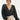 Front view of model wearing the Checked Out Cropped Satin Top that has black satin fabric with a monochromatic checker print, a surplice neck, a cropped waist, and long batwing sleeves.