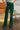 Frontal view of the With The Flow Pants that features a green colored velvet material, a high-rise fit, a side zipper, and a wide leg fit.