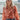 Frontal view of the All Class Top that features a salmon colored chiffon material, a floral print, a collar neck, a long cuffed sleeve, and a back elastic hemline.