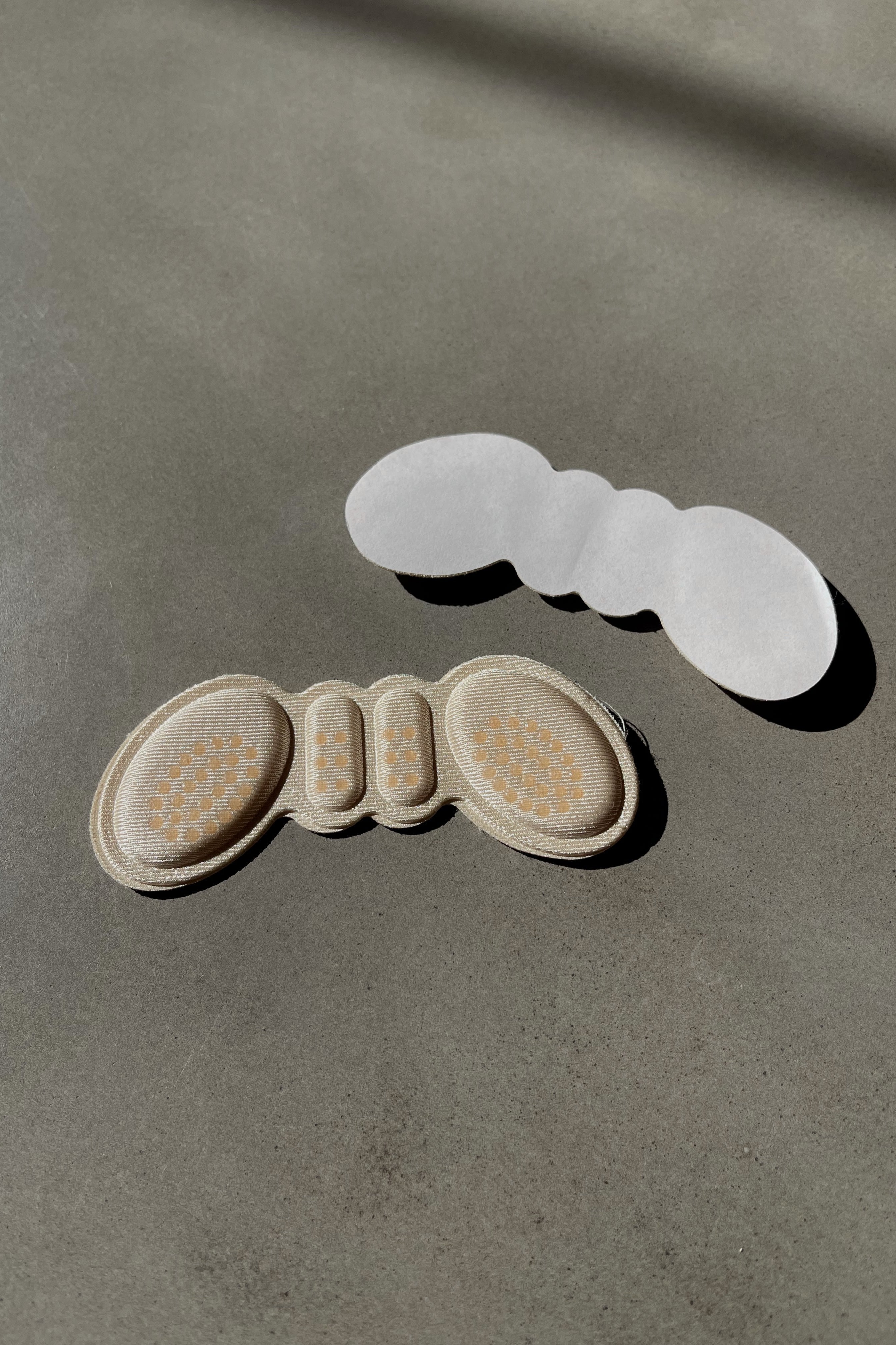 Flat lay view of the Heel Cushion Inserts in Nude. The Heel Cushion Inserts is designed to provide all day cushioning and support the back of the heel.