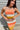 Frontal view of the Day Dreamer Tank Top that features a stretchy knit material, a multicolored thick stripe pattern, a rounded neck, ribbed hems, a sleeveless design with thick straps, and a cropped fit.