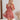 Frontal view of the Mystic Meadows Dress that features a light clay material, a scoop neckline with a tie detail, a half sleeve, a ruched elastic waist, a two-tiered bottom with a ruffle hem, a squared back, and a mini length.