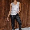 Full body front view of model wearing the Paris Champagne Sequin Tank Top that has beige sheer fabric, a champagne sequin design, beige lining, a v-neckline and a sleeveless body.
