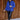 Full body front view of model wearing the Maren Blue Teddy Jacket that has royal blue faux-fur sherpa fabric, tortoise buttons, pockets, a collar, and long sleeves with buttoned cuffs.