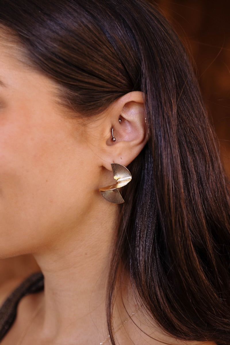 Side view of model wearing the Margaret Gold Dimensional Studs that feature gold stud with a dimensional shape.