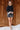 Full body view of model wearing the Zara Black & Silver Sequin Mini Skirt which features black sequin and silver sequin fabric, colorblock design, black lining, mini length and back zipper.