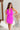 front view of model wearing the Don't Be Shy Dress , which features a purple material, a halter neck with a tie, pleat details on the straps, an open back, and a back zipper closure.