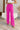 Front view of model wearing the Make A Statement Pants, which feature a pink chiffon material, a high-rise fit, a thick waist band, a wide leg fit, and a back zipper closure