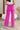 back view of model wearing the Make A Statement Pants, which feature a pink chiffon material, a high-rise fit, a thick waist band, a wide leg fit, and a back zipper closure