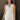 Front view of model wearing the Everlasting Bliss Romper that has white fabric, a pleated bottom with a lettuce hem, an elastic waist, a surplice neck with a tie and snap closure, and a keyhole back.