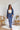 
Frontal view of the On Your Mark Pants that features a blue satin material, a high-rise fit, a thick waist band, a clasp and zipper front closure, side pockets, a wide leg fit, and two back pockets.
