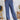 Frontal view of the On Your Mark Pants that features a blue satin material, a high-rise fit, a thick waist band, a clasp and zipper front closure, side pockets, a wide leg fit, and two back pockets.