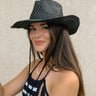 Front view of model wearing the Coastal Views Hat in Black which features black weave fabric and adjustable drawstring attached.