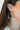  Side view of model wearing the Make It Fun Beaded Earrings which features gold closed hoops with multi, pastel color beads.