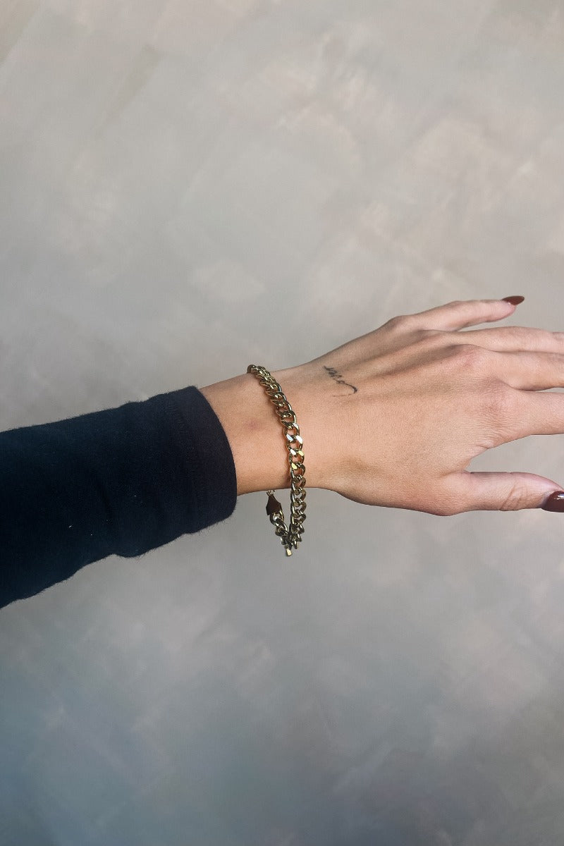 Front view of model wearing the Ava Gold Chain Adjustable Bracelet which features gold chain link with adjustable clasp closure.