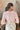 Back view of model wearing the Shine On Sequin Top in Pink, that has pink material with pink sequins, a pink lining, 3/4-length sleeves with shoulder pads, and an exposed back zipper
