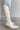 Side view of the Going Places Boot that features a white colored western style boot, featuring a white leather upper, western inspired embroidery, an almond toe, a 2" stacked heel, pull-on tabs for easy entry, and a side zipper.