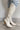 Side view of the Going Places Boot that features a white colored western style boot, featuring a white leather upper, western inspired embroidery, an almond toe, a 2" stacked heel, pull-on tabs for easy entry, and a side zipper.