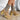 The Melanie Knit Boot is a mid-calf boot featuring a knit upper, a rubber lug sole, a 1" platform, and a 3" heel. 